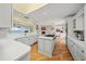 Spacious kitchen with white cabinets, a large island, and stunning water views at 204 N Washington Dr, Sarasota, FL 34236
