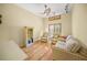 Comfortable living room features natural lighting, hardwood flooring, and a sofa with an accenting armchair at 204 N Washington Dr, Sarasota, FL 34236