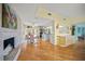Bright open-concept living space with hardwood floors, fireplace, and seamless flow into the kitchen at 204 N Washington Dr, Sarasota, FL 34236