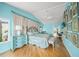 Serene primary bedroom featuring blue walls, hardwood floors, and a comfortable seating area at 204 N Washington Dr, Sarasota, FL 34236