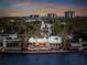 Waterfront home featuring a private pool, outdoor seating area, and stunning sunset views at 204 N Washington Dr, Sarasota, FL 34236