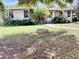 Inviting single-story home with a lovely front yard and mature landscaping features at 2104 Datura St, Sarasota, FL 34239