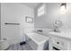 Bright bathroom features a modern tub, white vanity with marble countertop, and stylish patterned tile floors at 211 81St St # B, Holmes Beach, FL 34217