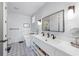 Bathroom featuring a double vanity, free-standing tub, and modern fixtures and finishes at 211 81St St # B, Holmes Beach, FL 34217