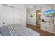 Comfortable bedroom with coastal decor, tv, and en-suite bathroom, creating a welcoming space at 211 81St St # B, Holmes Beach, FL 34217