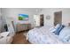 Spacious bedroom featuring wood floors, beachy decor, and a wall-mounted television at 211 81St St # B, Holmes Beach, FL 34217