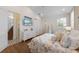 Bright bedroom featuring a TV, stylish decor, and a beach-themed comforter, staircase and closet at 211 81St St # B, Holmes Beach, FL 34217