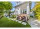 Charming porch with modern chairs, stairs and a walkway to the backyard at 211 81St St # B, Holmes Beach, FL 34217