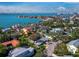 Scenic aerial view showcasing the neighborhood, with views of the bay and city skyline beyond the tree-lined streets at 2120 Oriole Dr, Sarasota, FL 34239