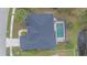 Top-down aerial shot of a home with pool, showcasing the roof, yard, and proximity to a pond at 2260 Island Creek Rd, Sarasota, FL 34240