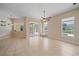 Open living room with tile flooring, ceiling fan, and sliding glass doors providing natural light at 2260 Island Creek Rd, Sarasota, FL 34240