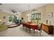 Open dining room with large window, view of the lanai, and decorative chandelier at 29627 Niagara Ct, Englewood, FL 34223