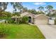 Well-maintained single-Gathering home with a lush green lawn and mature palm trees at 3007 Goodwater St, Sarasota, FL 34231