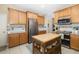 Modern kitchen featuring stainless steel appliances, wooden cabinets, and an island at 3007 Goodwater St, Sarasota, FL 34231