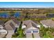 Aerial view of a beautiful home showcasing a large driveway, and lush landscaping at 3024 Sky Blue Cv, Bradenton, FL 34211