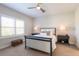 Cozy bedroom featuring a neutral color palette, ceiling fan, and plantation shutters for ample light control at 3024 Sky Blue Cv, Bradenton, FL 34211