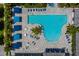 Aerial view of a community pool with sunshades and lounge seating beside a turquoise pool and hot tub at 3024 Sky Blue Cv, Bradenton, FL 34211