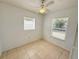 This is a bedroom with tiled floor, ceiling fan, and a window with blinds at 3035 Pershing Ave, Sarasota, FL 34234