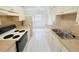 Functional kitchen featuring white cabinets, laminate countertops, and modern appliances at 3035 Pershing Ave, Sarasota, FL 34234