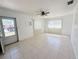 Bright living room featuring neutral walls, tile flooring, and a ceiling fan at 3035 Pershing Ave, Sarasota, FL 34234
