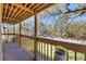 Relaxing balcony with a wooden railing overlooking a street and lush green trees at 3073 Willow Grn # 36, Sarasota, FL 34235