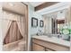 Neat bathroom features a shower-tub combo, a vanity with a sink, and a mirrored medicine cabinet at 3073 Willow Grn # 36, Sarasota, FL 34235