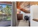 Bedroom featuring wood-paneled ceiling with office space near a sliding glass door at 3073 Willow Grn # 36, Sarasota, FL 34235