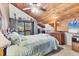 Bedroom with wood-paneled ceiling, fan, and a window offering a peaceful view at 3073 Willow Grn # 36, Sarasota, FL 34235