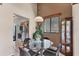 Cozy dining room features a glass table, adjacent to the kitchen, with a decorative hutch and window views at 3073 Willow Grn # 36, Sarasota, FL 34235