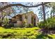 Exterior view of a multi-story condominium complex surrounded by trees and lush lawns at 3073 Willow Grn # 36, Sarasota, FL 34235