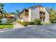 Exterior view of condos featuring screened balconies, mature landscaping, and a paved walkway at 3073 Willow Grn # 36, Sarasota, FL 34235