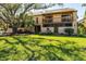 Two-story condo building with balconies, mature trees, and well-maintained landscaping at 3073 Willow Grn # 36, Sarasota, FL 34235