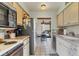 Efficient kitchen with essential appliances and a view into the dining area with a glass table at 3073 Willow Grn # 36, Sarasota, FL 34235