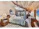 Cozy main bedroom with wood-clad vaulted ceiling, balcony access, and neutral decor at 3073 Willow Grn # 36, Sarasota, FL 34235