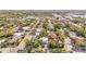 Aerial view of a home nestled in a mature neighborhood with tree-lined streets and proximity to commercial areas at 3319 S Osprey Ave, Sarasota, FL 34239