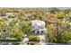 Stunning aerial view of a modern white house nestled among lush trees, showcasing its prime location and curb appeal at 3319 S Osprey Ave, Sarasota, FL 34239