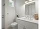 Neat half bath with white cabinets, quartz counters, and modern fixtures at 3319 S Osprey Ave, Sarasota, FL 34239