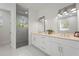 Elegant bathroom with double vanity, quartz countertop, modern lighting, and walk-in shower at 3319 S Osprey Ave, Sarasota, FL 34239