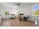 Cozy Bedroom with wood floors, white walls, windows, crib, dresser, and rocker with ottoman at 3319 S Osprey Ave, Sarasota, FL 34239