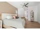 Comfortable bedroom featuring a ceiling fan, patterned wallpaper and a large, inviting bed at 3319 S Osprey Ave, Sarasota, FL 34239