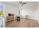 Bright Bedroom features wood floors, white walls, ceiling fan, crib, dresser, and rocker at 3319 S Osprey Ave, Sarasota, FL 34239