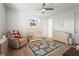 Warm Bedroom features wood floors, ceiling fan, crib, glider, rug, and accent wall decor at 3319 S Osprey Ave, Sarasota, FL 34239