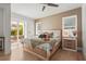 Cozy bedroom with warm-toned wallpaper, hardwood floors, and glass doors leading to outdoor patio at 3319 S Osprey Ave, Sarasota, FL 34239