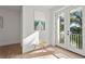 Hallway with painting leading to a balcony with french doors at 3319 S Osprey Ave, Sarasota, FL 34239