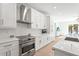Modern white kitchen with stainless steel appliances and custom cabinets at 3319 S Osprey Ave, Sarasota, FL 34239