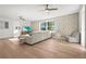 Spacious living room with a large window, hardwood floors, and stylish contemporary decor at 3319 S Osprey Ave, Sarasota, FL 34239