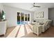 Bright living room with hardwood floors, a white sofa, and sliding glass doors to a pool at 3319 S Osprey Ave, Sarasota, FL 34239