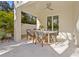 Covered patio dining area with stylish seating and modern ceiling fan for comfortable outdoor entertaining at 3319 S Osprey Ave, Sarasota, FL 34239