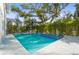 Sparkling pool with an attached hot tub, surrounded by lush landscaping and a modern patio at 3319 S Osprey Ave, Sarasota, FL 34239