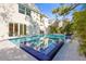 Luxury pool and spa with mosaic tiling, complemented by modern outdoor design and a sleek, comfortable outdoor living area at 3319 S Osprey Ave, Sarasota, FL 34239